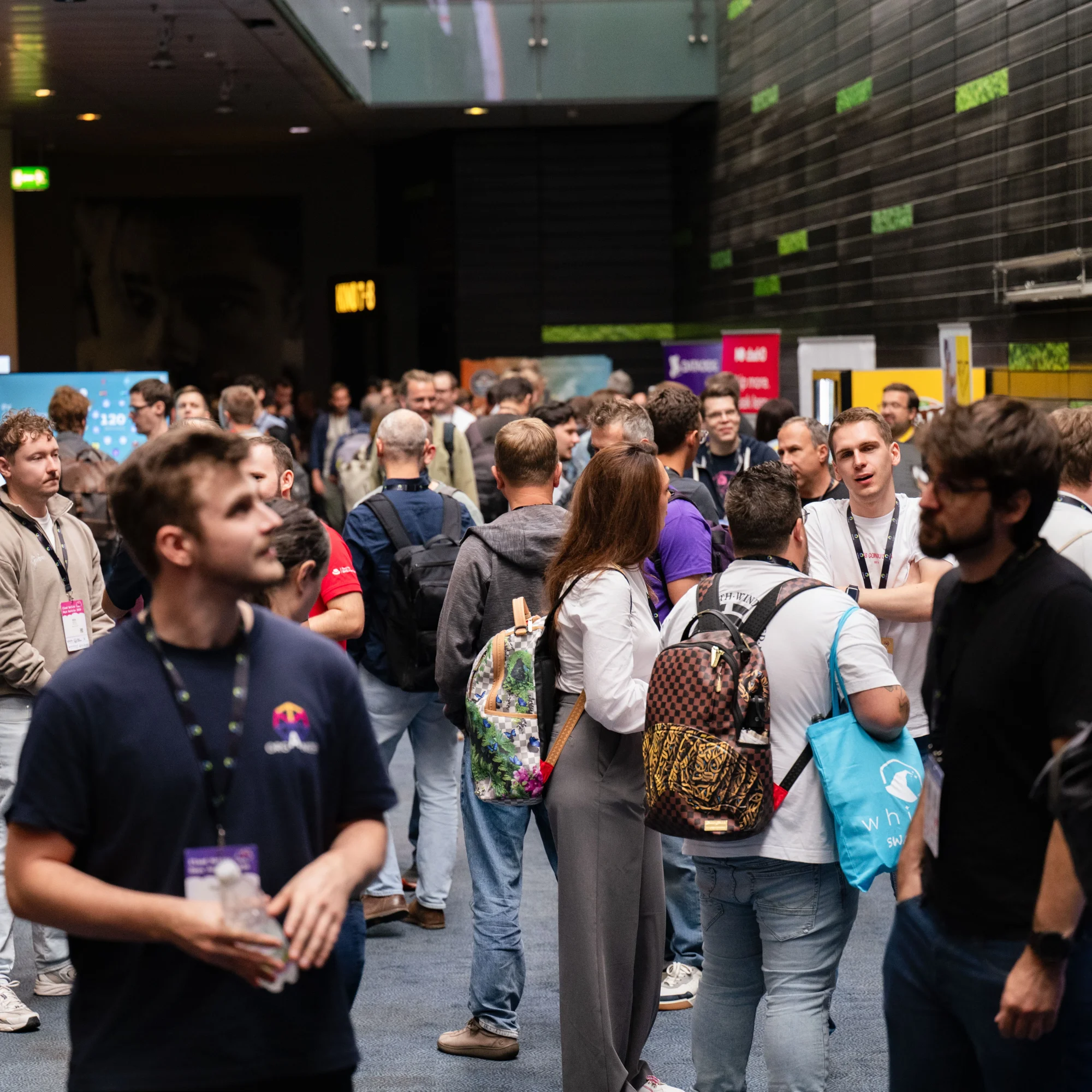 Attendees mingling in the foyer between sessions